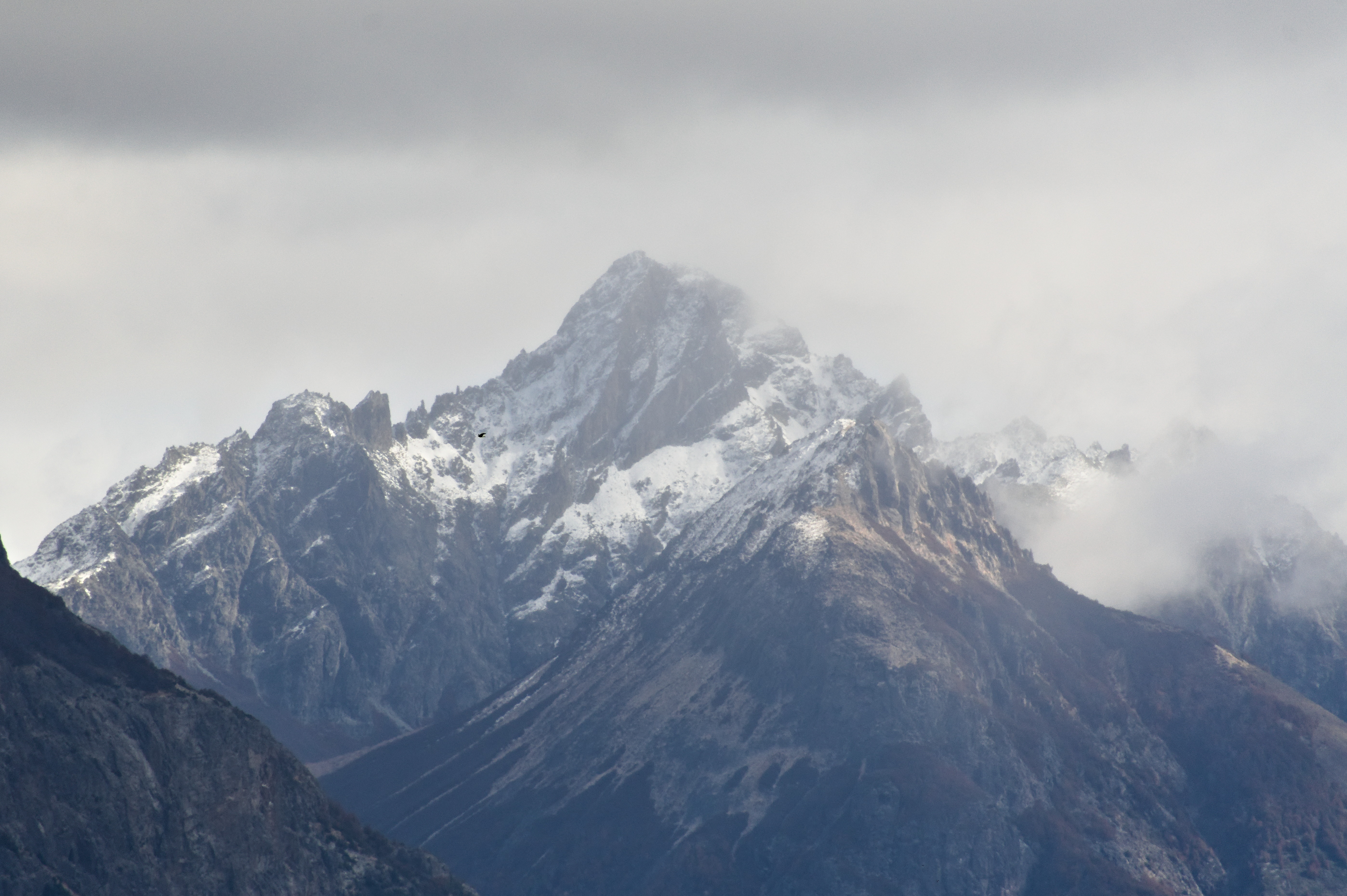 Imposing view of the ridge of a snow-capped mountain.